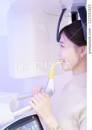 Young woman taking a dental x-ray Young woman taking a dental x-ray 122331925
