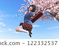 High school girl jumping high in front of a cherry blossom tree 122332537