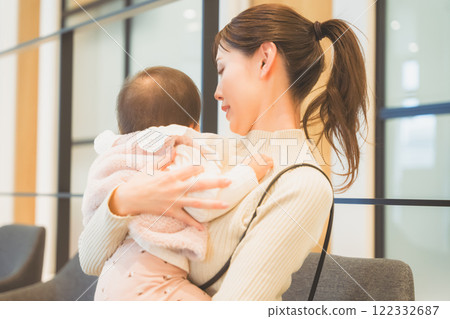 Infant and mother undergoing infant check-up Infant and mother undergoing infant check-up 122332687