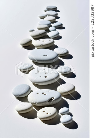 Abstract arranged white pebbles on smooth surface casting shadows. AI generation Abstract arranged white pebbles on smooth surface casting shadows. AI generation 122332997
