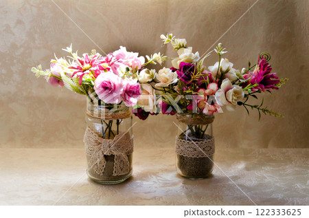 Close-up of a gentle floral composition in a vase on the light background Close-up of a gentle floral composition in a vase on the light background 122333625