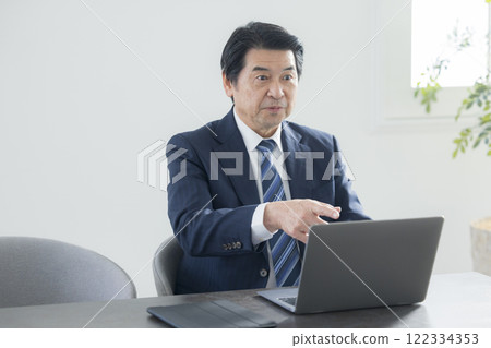 A businessman who works on a personal computer 122334353