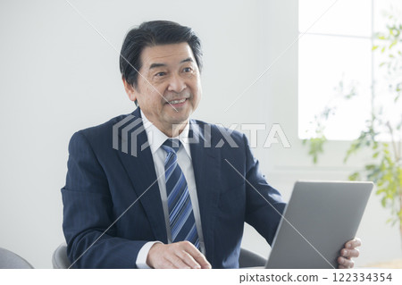 A businessman who works on a personal computer 122334354
