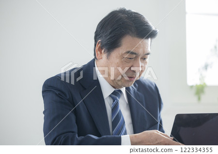 A businessman who works on a personal computer 122334355