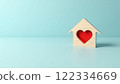 Wooden House Model with Red Heart Symbol of Home, Love, and Care for Real Estate or Charity Concepts 122334669