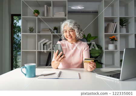 Elderly online shopping senior credit card use at home technology lifestyle digital engagement Elderly online shopping senior credit card use at home technology lifestyle digital engagement 122335001
