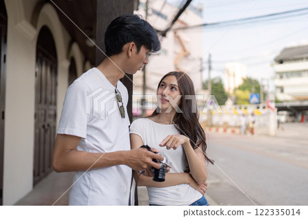 Traveling couple captures memories in city streets outdoor natural light intimate viewpoint Traveling couple captures memories in city streets outdoor natural light intimate viewpoint 122335014
