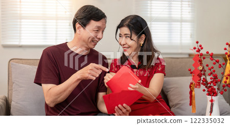 Chinese new year celebration home lifestyle content warm environment close-up view elderly couple enjoying together 122335032