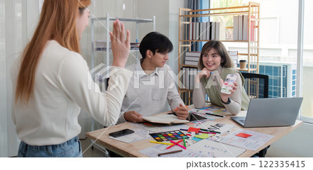 Creative UX UI team collaborating on design project in a modern office, showcasing diverse professionals Creative UX UI team collaborating on design project in a modern office, showcasing diverse professionals 122335415