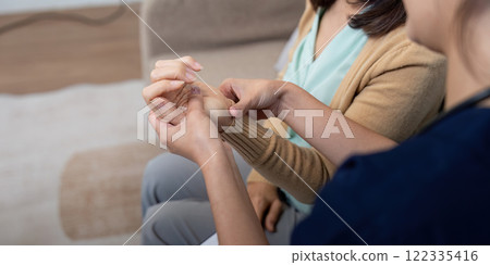 Caregiver examining elderly patient for symptoms of disease during a compassionate check up 122335416