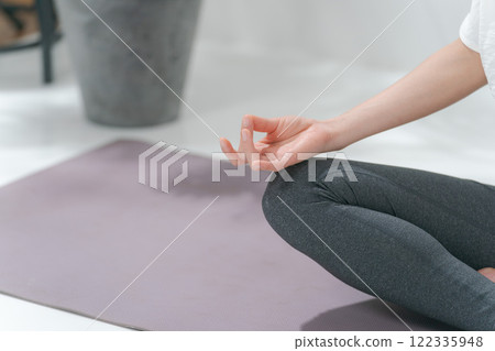 Hands of a woman in her 30s doing yoga 122335948