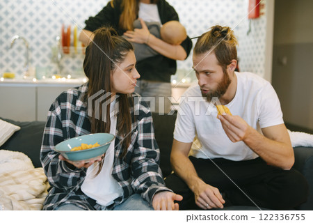 Casual family interactions at home, enjoying delicious snacks, create lasting memories Casual family interactions at home, enjoying delicious snacks, create lasting memories 122336755