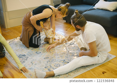 Engaging in delightful family playtime within the comfort of a cozy and inviting living room 122336848