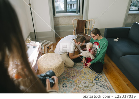 Capture the joy of a Family Christmas Photo Session with a Child in a warm Living Room Capture the joy of a Family Christmas Photo Session with a Child in a warm Living Room 122337039