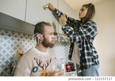 Enjoying Cozy and Memorable Holiday Decorating Moments Together in a Stylish Modern Kitchen 122337117