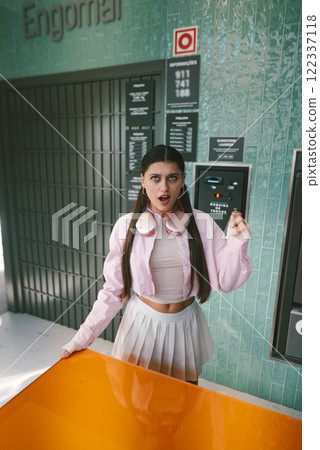 A Stylish Young Woman Posing in a Modern Setting Surrounded by Bright, Vibrant Colors A Stylish Young Woman Posing in a Modern Setting Surrounded by Bright, Vibrant Colors 122337118
