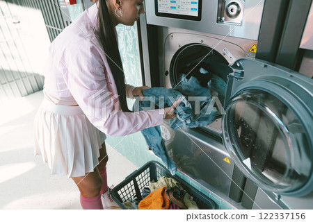 Washing clothes within a modern and wellequipped laundry facility is an essential task 122337156