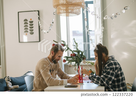 A Cozy Indoor Scene Featuring a Couple Engaging Together in a Creative Activity Together A Cozy Indoor Scene Featuring a Couple Engaging Together in a Creative Activity Together 122337220