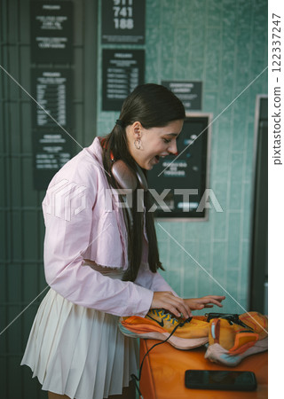 A young woman is actively DJing in a modern and vibrant setup that exudes creativity and fun 122337247