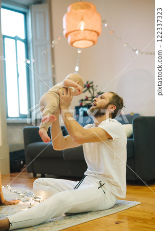 A Joyful and Heartwarming Interaction Between Parent and Baby in A Cozy and Comfortable Setting 122337323
