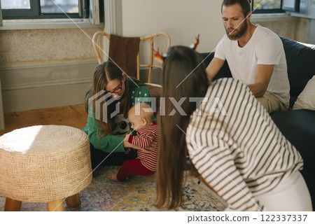 Enjoying Heartwarming Family Bonding Moments with a Baby in a Cozy Living Room Space Enjoying Heartwarming Family Bonding Moments with a Baby in a Cozy Living Room Space 122337337