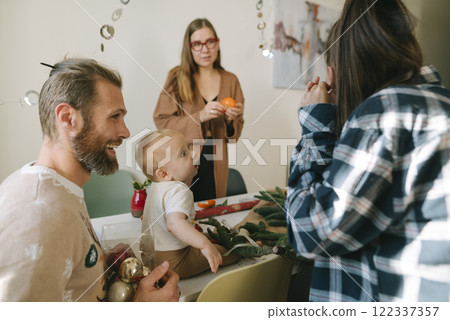 A Cheerful and Joyful Family Gathering with a Happy Toddler During the Festive Holiday Season 122337357