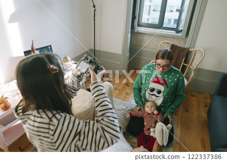 A Heartwarming Festive Family Moment with an Adorable Baby in a Cozy, Joyful Setting 122337386
