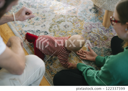 A Crawling Baby Engaged in a Playful Setting Surrounded by a Loving Family Atmosphere 122337399