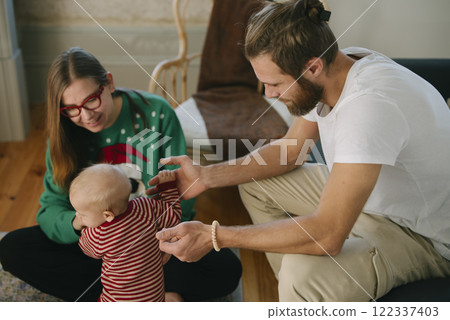 Family Moments Enjoying Playful Interactions with Baby in a Cozy Living Room Space 122337403