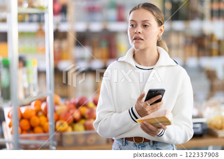 shopper scans the barcode on a cheese package 122337908