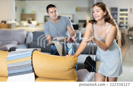 Boyfriend and girlfriend are choosing color of sofa in furniture store Boyfriend and girlfriend are choosing color of sofa in furniture store 122338127