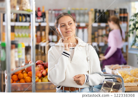 Young woman in supermarket 122338308