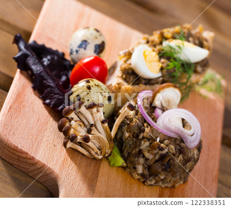 Tasty pate from button mushrooms with quail egg, onions and greens Tasty pate from button mushrooms with quail egg, onions and greens 122338351