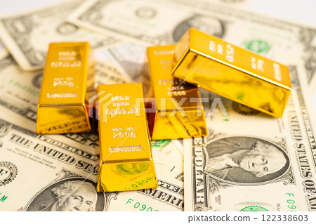 Gold bar on US dollar banknotes money and graph, economy finance exchange trade investment. 122338603
