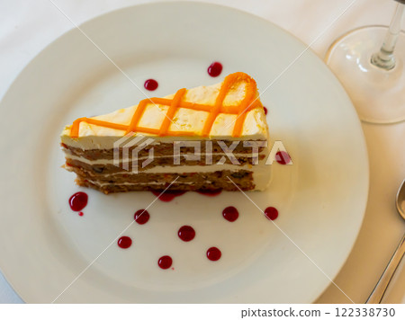 Slice of fresh carrot cake served on plate Slice of fresh carrot cake served on plate 122338730