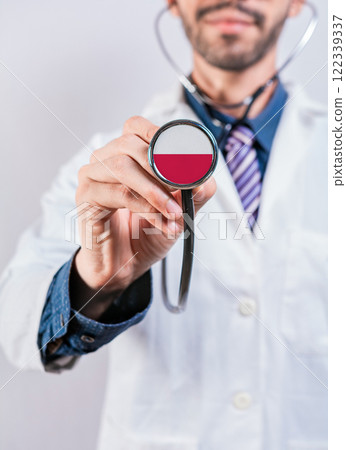 Poland health and medical insurance concept. Polish Healthcare System, doctor holding stethoscope Poland health and medical insurance concept. Polish Healthcare System, doctor holding stethoscope 122339337