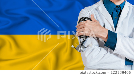 Doctor with stethoscope on Ukraine flag. Doctor holding stethoscope on Ukraine flag 122339406
