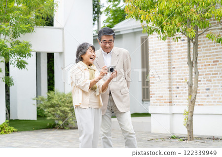 Senior couple, senior holding a camera Senior couple, senior holding a camera 122339949