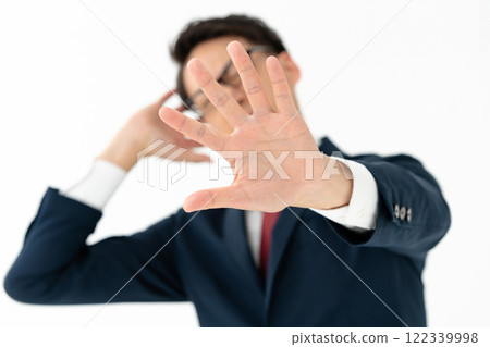 A man who makes a stop gesture A man who makes a stop gesture 122339998