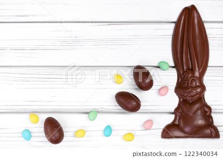 Easter chocolate bunny with assorted eggs on white table. Easter chocolate bunny with assorted eggs on white table. 122340034