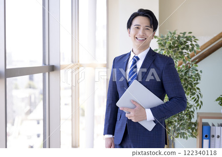 Young man wearing a business suit 122340118