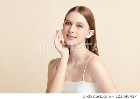 Beautiful young woman with clean fresh skin on beige background, Face care, Facial treatment, Cosmetology, beauty and spa, women portrait. 122340487