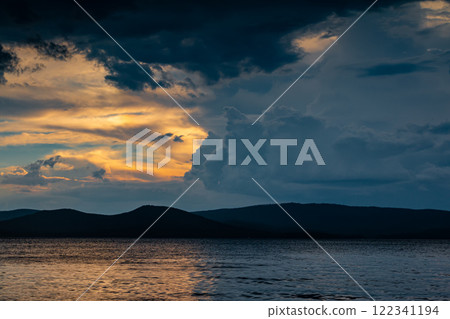 Cloudy evening before rain on a scenic lake Cloudy evening before rain on a scenic lake 122341194