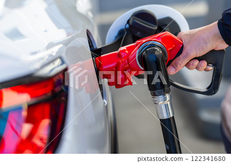 一個在加油站加油的人 122341680