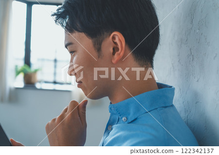 Men looking at smartphones Men looking at smartphones 122342137