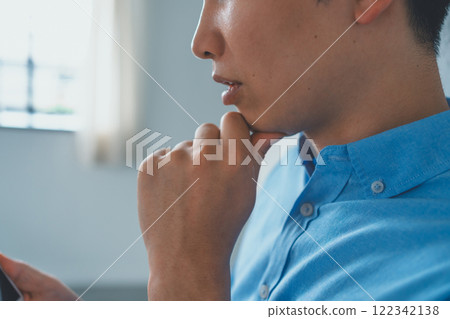 Men looking at smartphones Men looking at smartphones 122342138