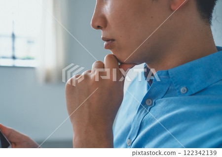 Men looking at smartphones Men looking at smartphones 122342139