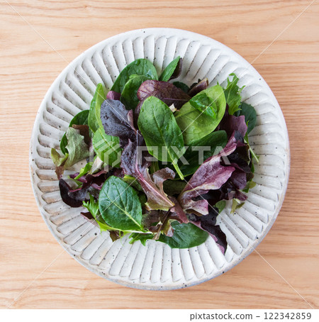 Baby leaves on a white plate Baby leaves on a white plate 122342859