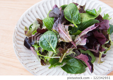 Baby leaves on a white plate Baby leaves on a white plate 122342931
