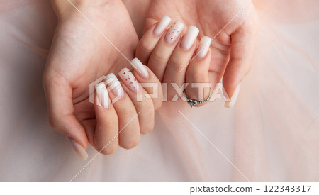 Female hands with fashionable ombre manicure on pink background Female hands with fashionable ombre manicure on pink background 122343317